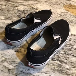 Vans size 9 slip on black shoes with white trim.